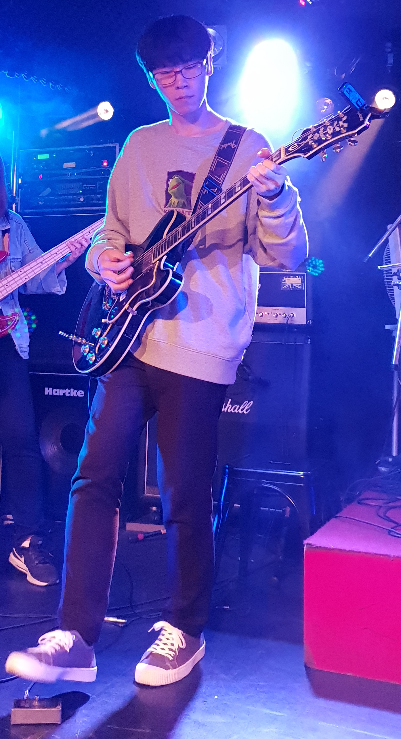 Photo of me playing an electric guitar on a stage